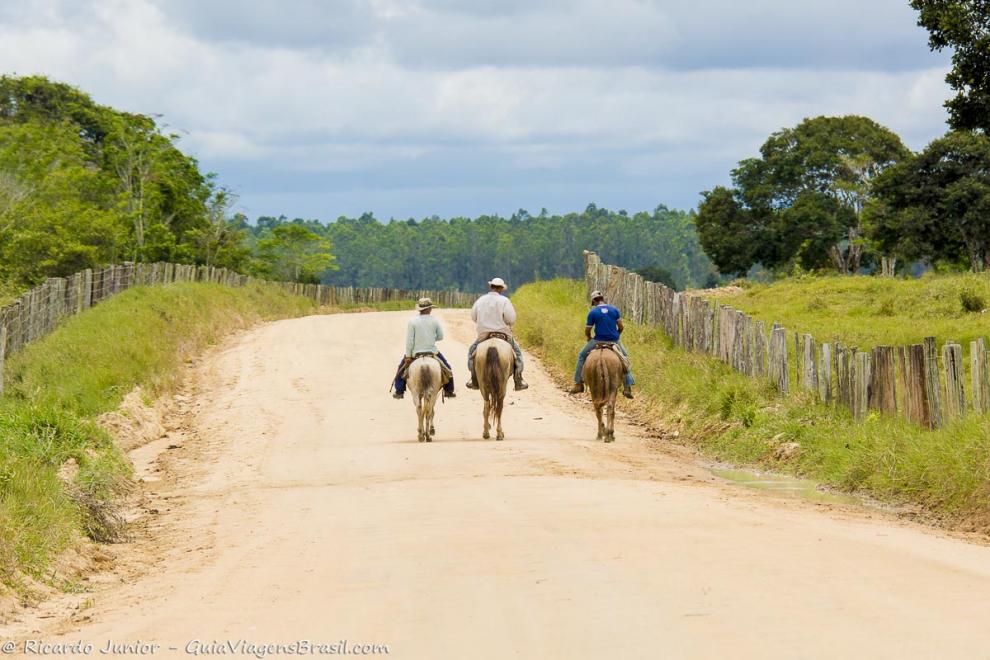Imagem de três cavaleiros na estrada para Caraíva.